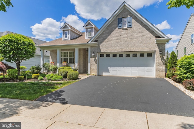 17 San Marco, West Windsor, NJ 08550 - view of front of property featuring covered porch, brick siding, and asphalt driveway