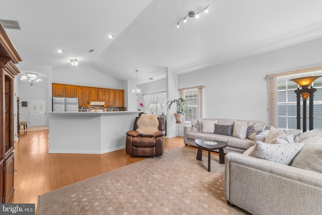17 San Marco, West Windsor, NJ 08550 - living room with lofted ceiling, light wood-style flooring, and a chandelier