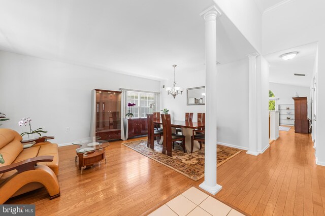 17 San Marco, West Windsor, NJ 08550 - living area with decorative columns, light wood-style floors, a chandelier, and baseboards