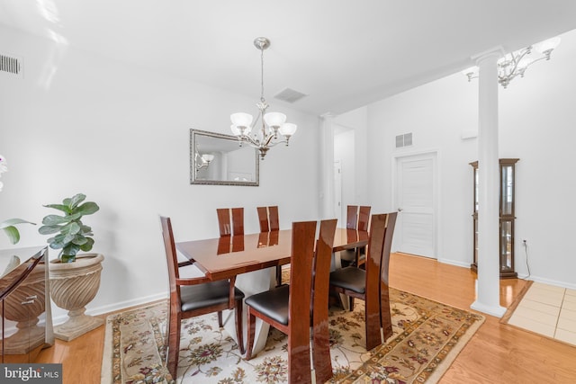 17 San Marco, West Windsor, NJ 08550 - dining room with ornate columns, light wood finished floors, a chandelier, and baseboards