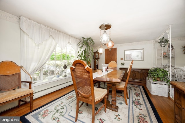 dining space with wood finished floors