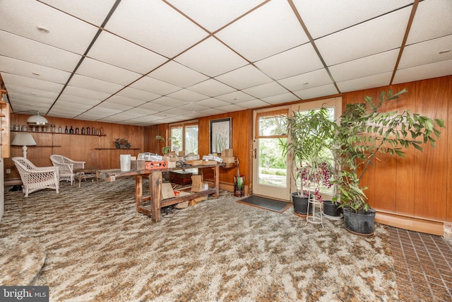 carpeted office space with wood walls