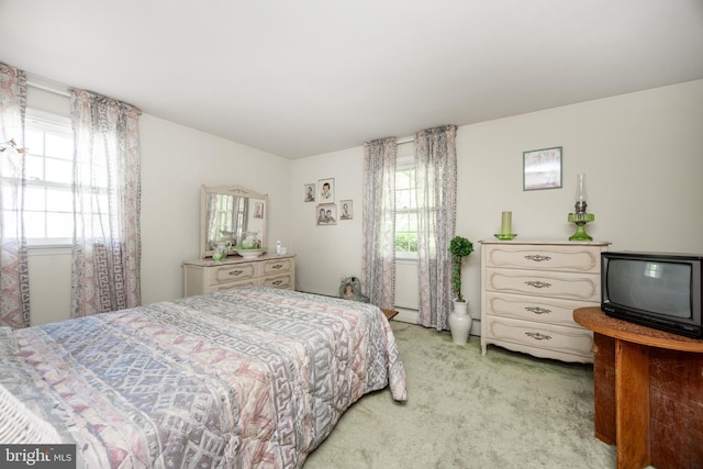 bedroom featuring light carpet