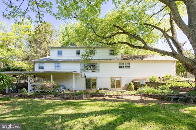 rear view of property featuring a yard
