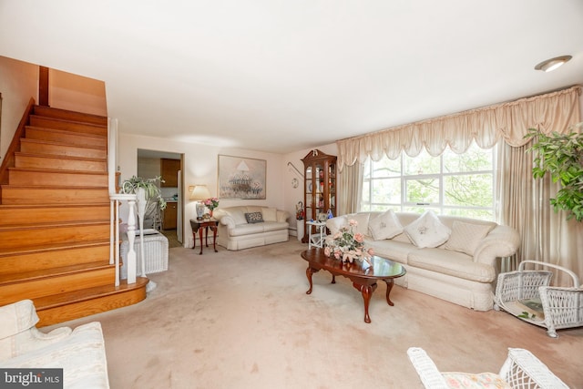 living room with carpet flooring and stairway