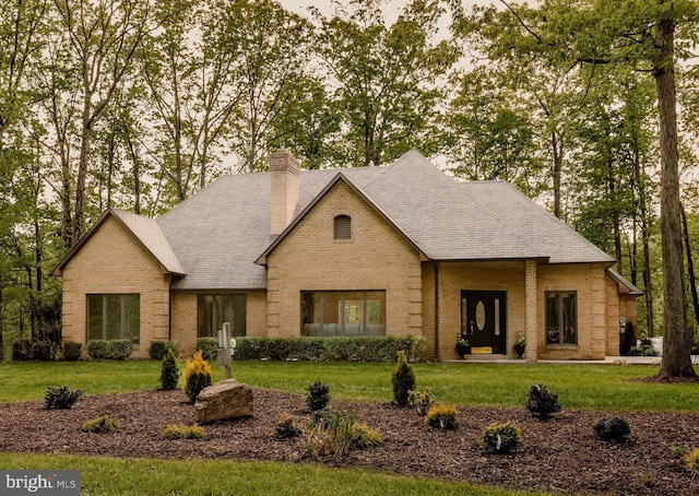 28 Stillwater Ct, Ridgeley, WV 26753 - view of front facade featuring brick siding, a front lawn, a chimney, and roof with shingles