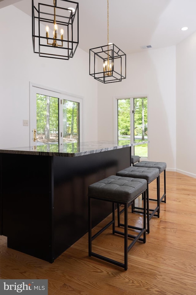 28 Stillwater Ct, Ridgeley, WV 26753 - bar featuring a chandelier, plenty of natural light, light wood-style flooring, recessed lighting, and a high ceiling