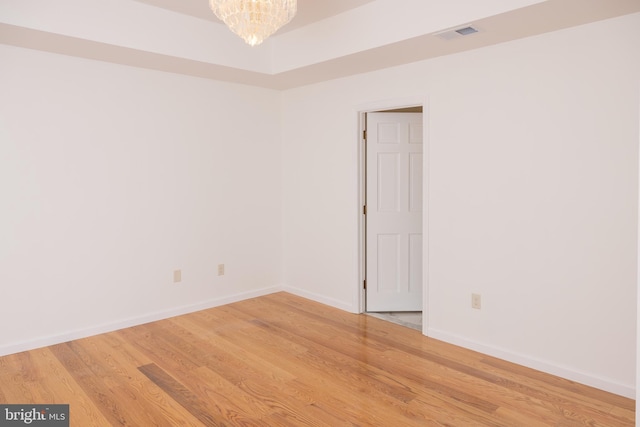 28 Stillwater Ct, Ridgeley, WV 26753 - unfurnished room with light wood-style flooring, a chandelier, and baseboards