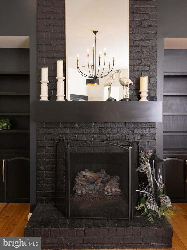 28 Stillwater Ct, Ridgeley, WV 26753 - detailed view of a fireplace, wood finished floors, a chandelier, and built in shelves