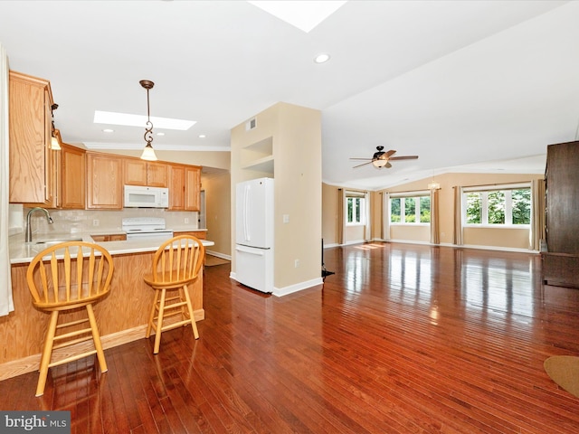 22028 Beaverbrook Dr, Smithsburg, MD 21783 - kitchen featuring white appliances, a skylight, open floor plan, a peninsula, and light countertops