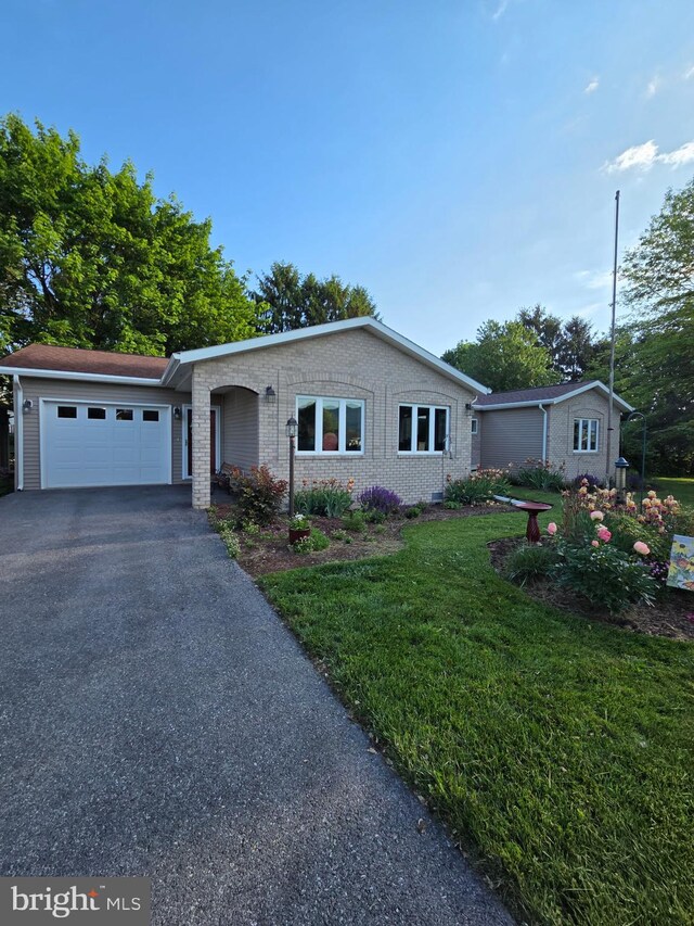 22028 Beaverbrook Dr, Smithsburg, MD 21783 - single story home featuring a garage, driveway, a front yard, and brick siding