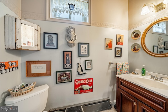 half bathroom with toilet and vanity
