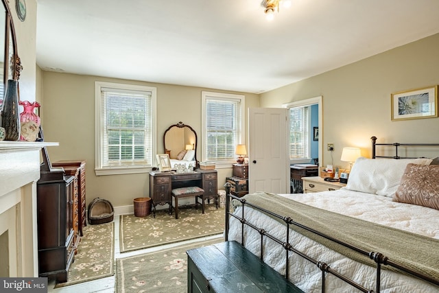 bedroom featuring wood finished floors and baseboards