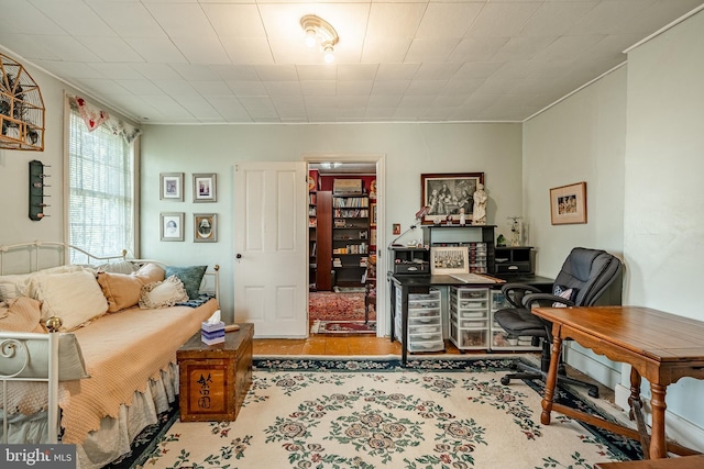 office space featuring ornamental molding and wood finished floors