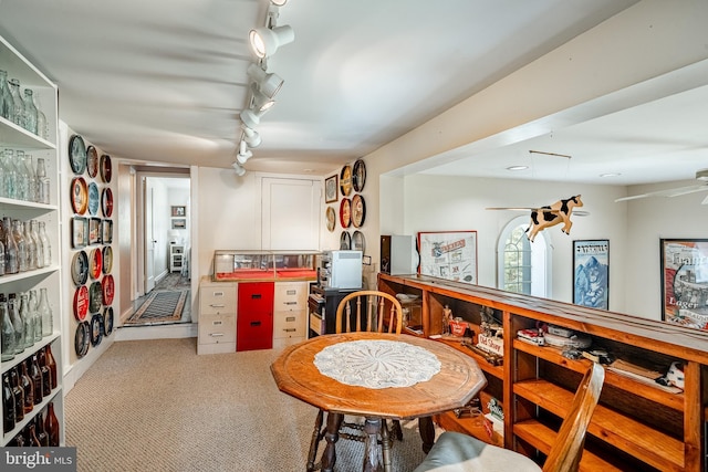 dining space featuring track lighting and carpet floors