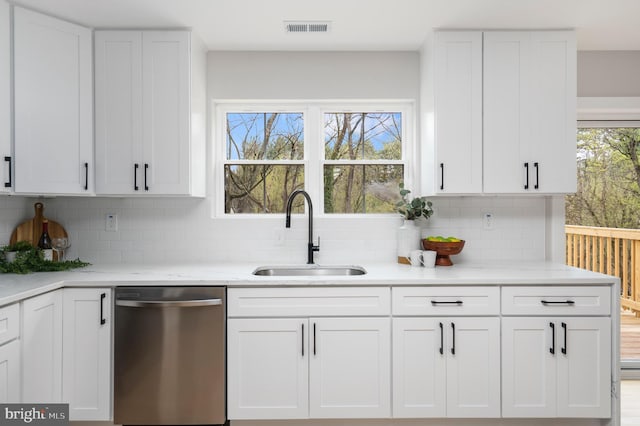 901 E Quaker Bottom Rd, Sparks Glencoe, MD 21152 - kitchen with stainless steel dishwasher, a sink, white cabinetry, and backsplash
