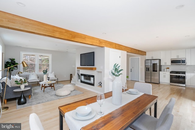 901 E Quaker Bottom Rd, Sparks Glencoe, MD 21152 - living area with light wood finished floors, a glass covered fireplace, and beam ceiling