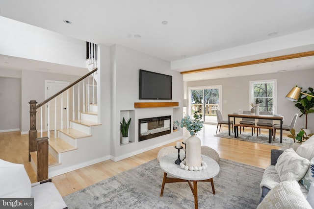 901 E Quaker Bottom Rd, Sparks Glencoe, MD 21152 - living area with wood finished floors, a glass covered fireplace, stairway, and baseboards