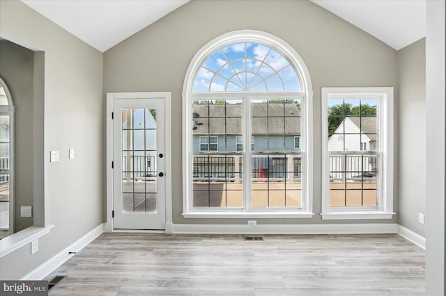 6624 Aaron Mee Way, Baltimore, MD 21237 - doorway with vaulted ceiling, light wood-type flooring, and baseboards