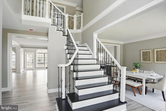 6624 Aaron Mee Way, Baltimore, MD 21237 - stairway with wood finished floors, crown molding, and baseboards