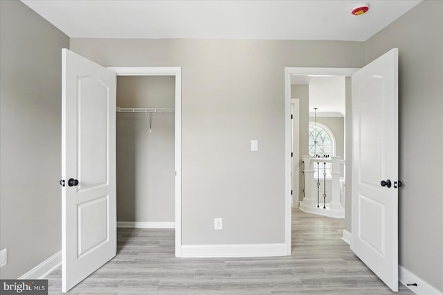 6624 Aaron Mee Way, Baltimore, MD 21237 - unfurnished bedroom featuring light wood-style floors, baseboards, and a closet