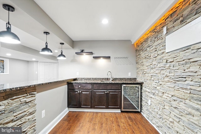 6624 Aaron Mee Way, Baltimore, MD 21237 - indoor wet bar with wine cooler, wood finished floors, baseboards, pendant lighting, and recessed lighting