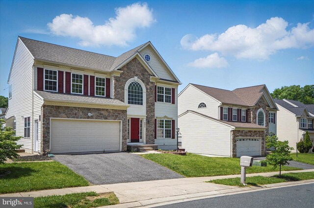6624 Aaron Mee Way, Baltimore, MD 21237 - view of front facade featuring stone siding, an attached garage, driveway, and a front lawn
