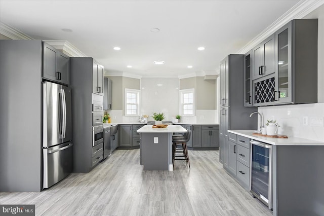 6624 Aaron Mee Way, Baltimore, MD 21237 - kitchen featuring freestanding refrigerator, wine cooler, gray cabinetry, a breakfast bar, and a sink