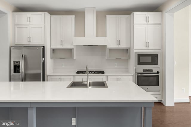 42289 Porter Rdg, Brambleton, VA 20148 - kitchen featuring stainless steel appliances, wall chimney range hood, a sink, and white cabinets