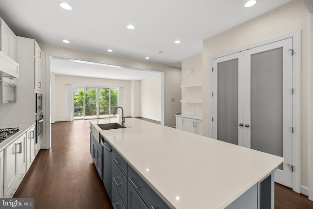 42289 Porter Rdg, Brambleton, VA 20148 - kitchen with appliances with stainless steel finishes, a sink, white cabinets, dark wood finished floors, and a kitchen island with sink