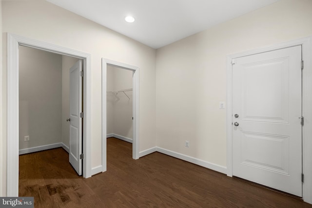 42289 Porter Rdg, Brambleton, VA 20148 - unfurnished bedroom featuring a spacious closet, dark wood finished floors, baseboards, a closet, and recessed lighting