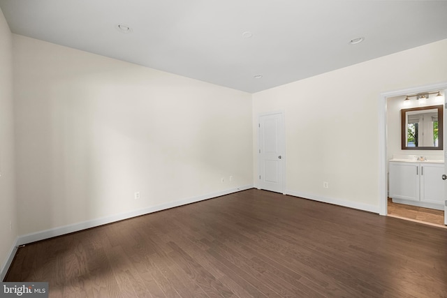 42289 Porter Rdg, Brambleton, VA 20148 - spare room with dark wood-style floors, baseboards, and a sink