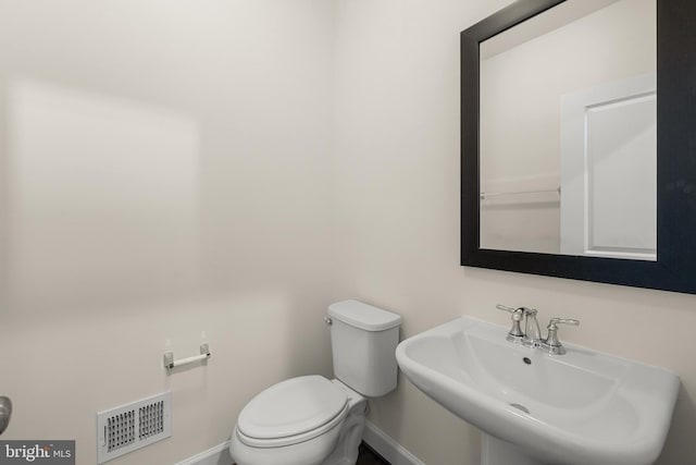 42289 Porter Rdg, Brambleton, VA 20148 - half bathroom featuring baseboards, a sink, and toilet