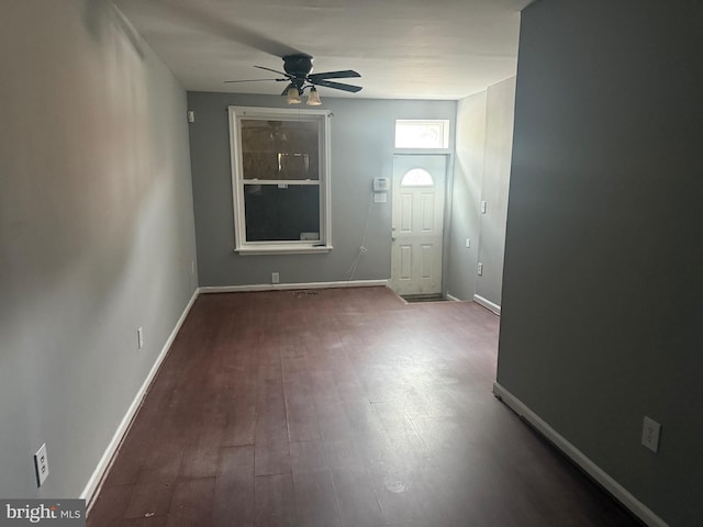 entryway with a ceiling fan, wood finished floors, and baseboards