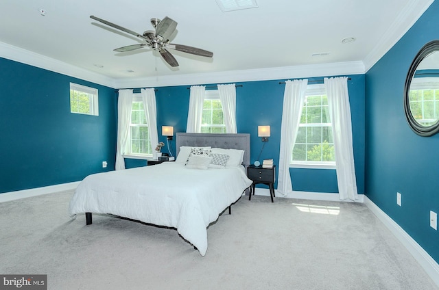 bedroom featuring crown molding, carpet, baseboards, and multiple windows