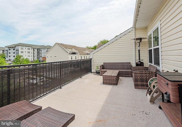 view of patio / terrace with a residential view, an outdoor living space, and a balcony