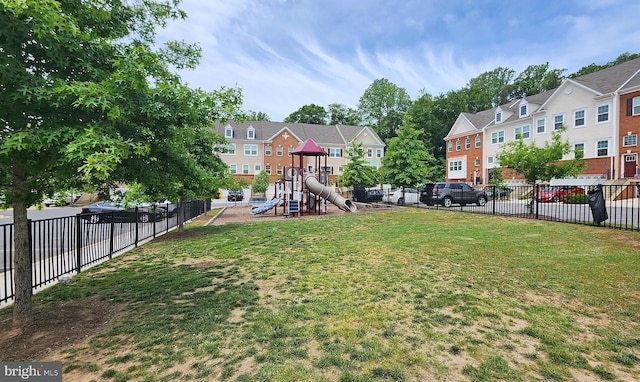 view of yard featuring a playground and a residential view