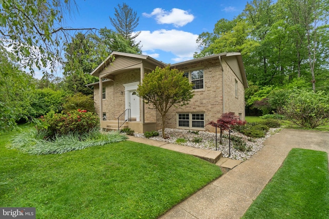 view of front of property with brick siding and a front lawn