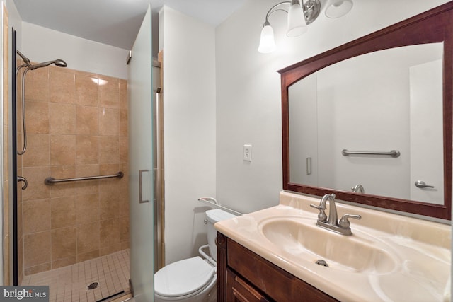 full bathroom with a shower stall, toilet, and vanity