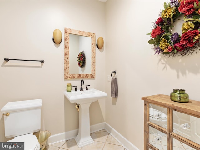 bathroom with tile patterned floors, toilet, and baseboards