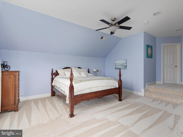 bedroom featuring light colored carpet, baseboards, lofted ceiling, and a ceiling fan