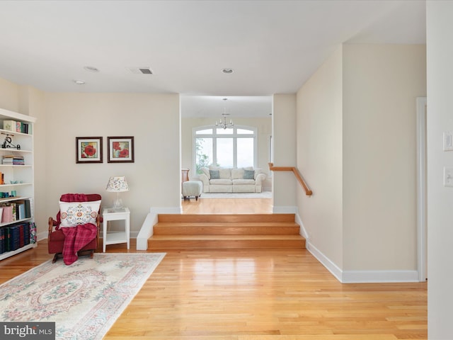 living area featuring light wood-type flooring, baseboards, a chandelier, recessed lighting, and stairs