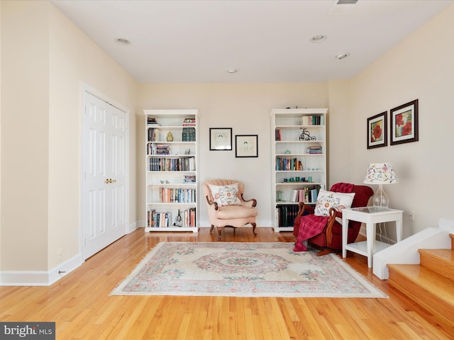 living area with wood finished floors and baseboards