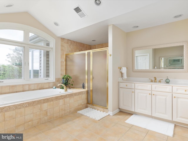 bathroom with plenty of natural light, tile patterned flooring, a bath, a shower stall, and vaulted ceiling