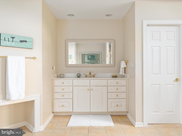 bathroom featuring tile patterned flooring, baseboards, and vanity