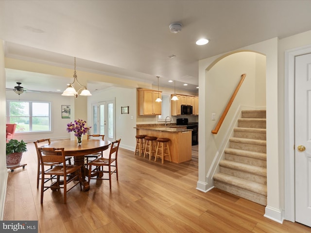 dining space featuring light wood-style flooring, a ceiling fan, stairs, recessed lighting, and baseboards