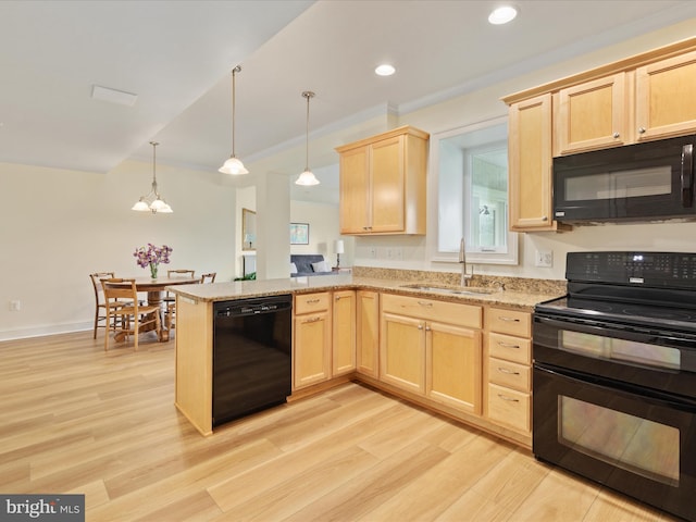 kitchen with black appliances, a sink, light brown cabinets, light wood-style flooring, and recessed lighting