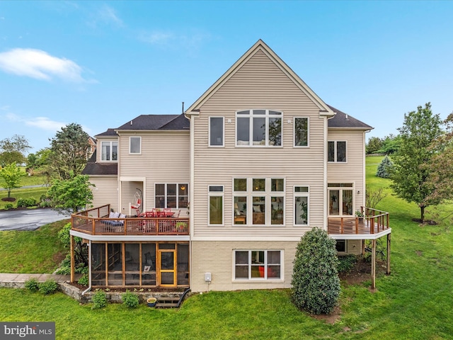 back of property featuring a yard and a deck