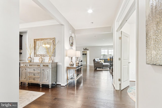 hall with dark wood-style flooring, recessed lighting, baseboards, and crown molding