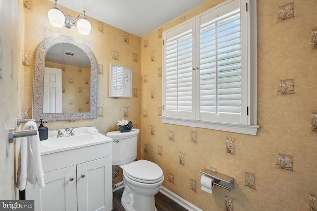 bathroom featuring toilet and vanity